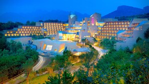 A large, modern hotel with multiple buildings, a prominent tower, and a well-lit facade. - CITIC Jinling Hotel (Pinggu)