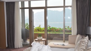 A hotel room with a large window, a bed, a sofa, and a small table. - CITIC Jinling Hotel (Pinggu)