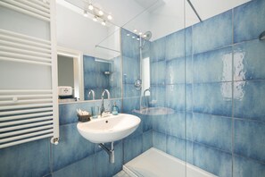 Klassieke driepersoonskamer | Badkamer | Een douche, een regendouche, gratis toiletartikelen, een haardroger