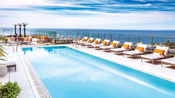 Een buitenzwembad, een verwarmd zwembad, ligstoelen bij het zwembad