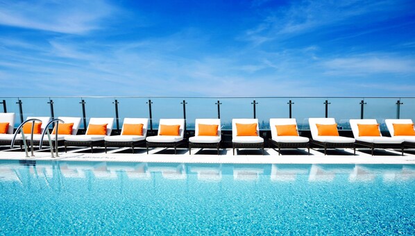 Outdoor pool, a heated pool, open 7:00 AM to 11:00 PM, pool loungers