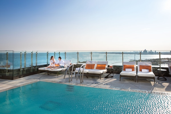 Outdoor pool, a heated pool, open 7:00 AM to 11:00 PM, pool loungers