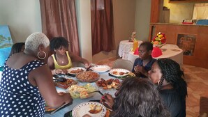 A group of people dining at a table with various dishes.