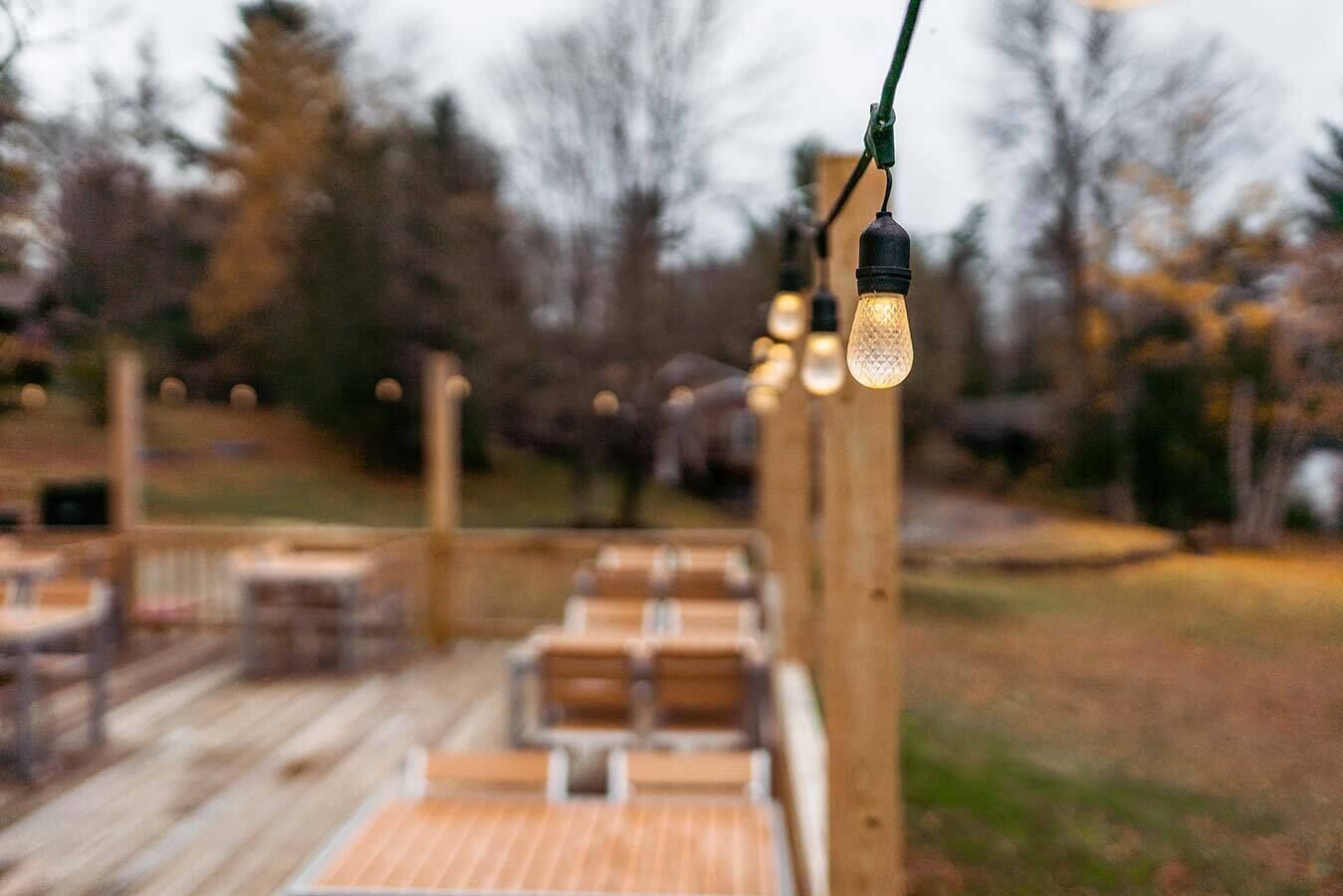 An outdoor deck with wooden flooring and seating.