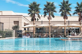 Outdoor pool, cabanas (surcharge), pool umbrellas at Marriott Irvine Spectrum