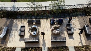 A rooftop patio with outdoor seating, a fire pit, and a view of the surrounding area. - Courtyard by Marriott Dallas Flower Mound (Flower Mound)