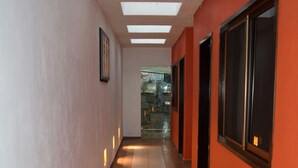 A corridor with a tiled floor, recessed lighting, and a skylight. - Casa Palmas (Guanajuato)