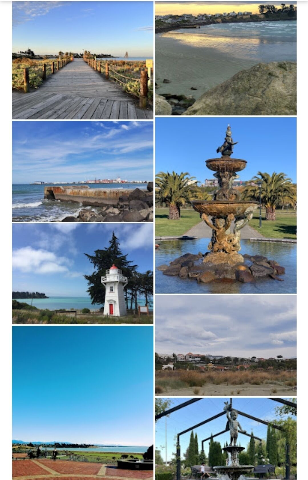 Une promenade en bois menant à une plage, une jetée rocheuse, un phare blanc et une statue dans un parc.