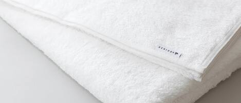 A stack of white towels with a label.