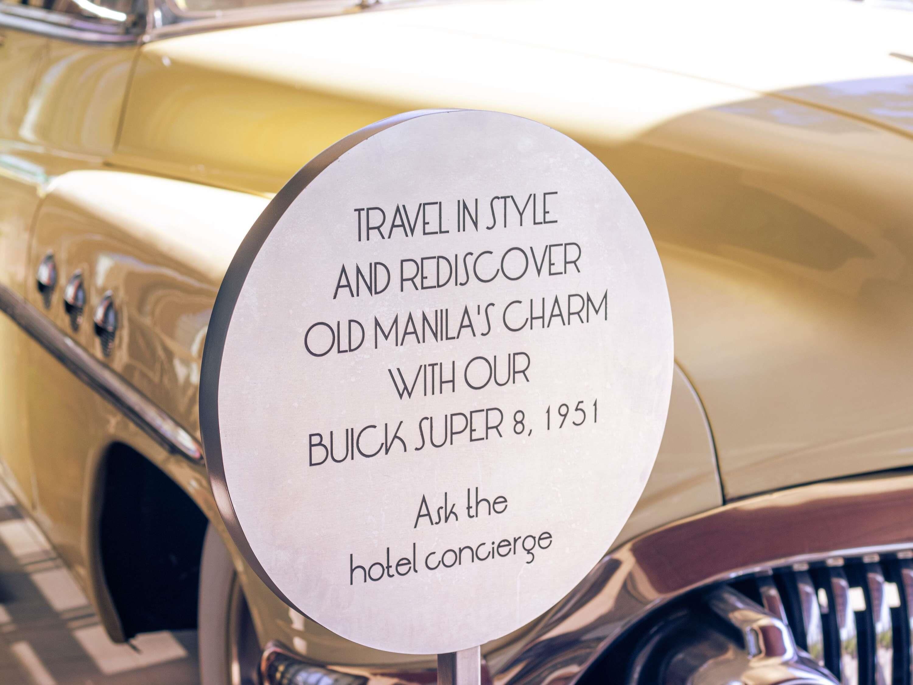 A sign on a vintage car promoting travel and rediscovery of Old Manila with a Buick Super 8, 1951.
