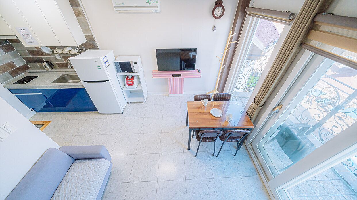 A compact living space with a kitchenette, a dining area, and a seating area.