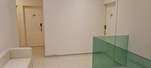 A hallway with two doors, one marked 216 and the other 217, and a glass partition. - Star Tree Homestay (Kuantan)