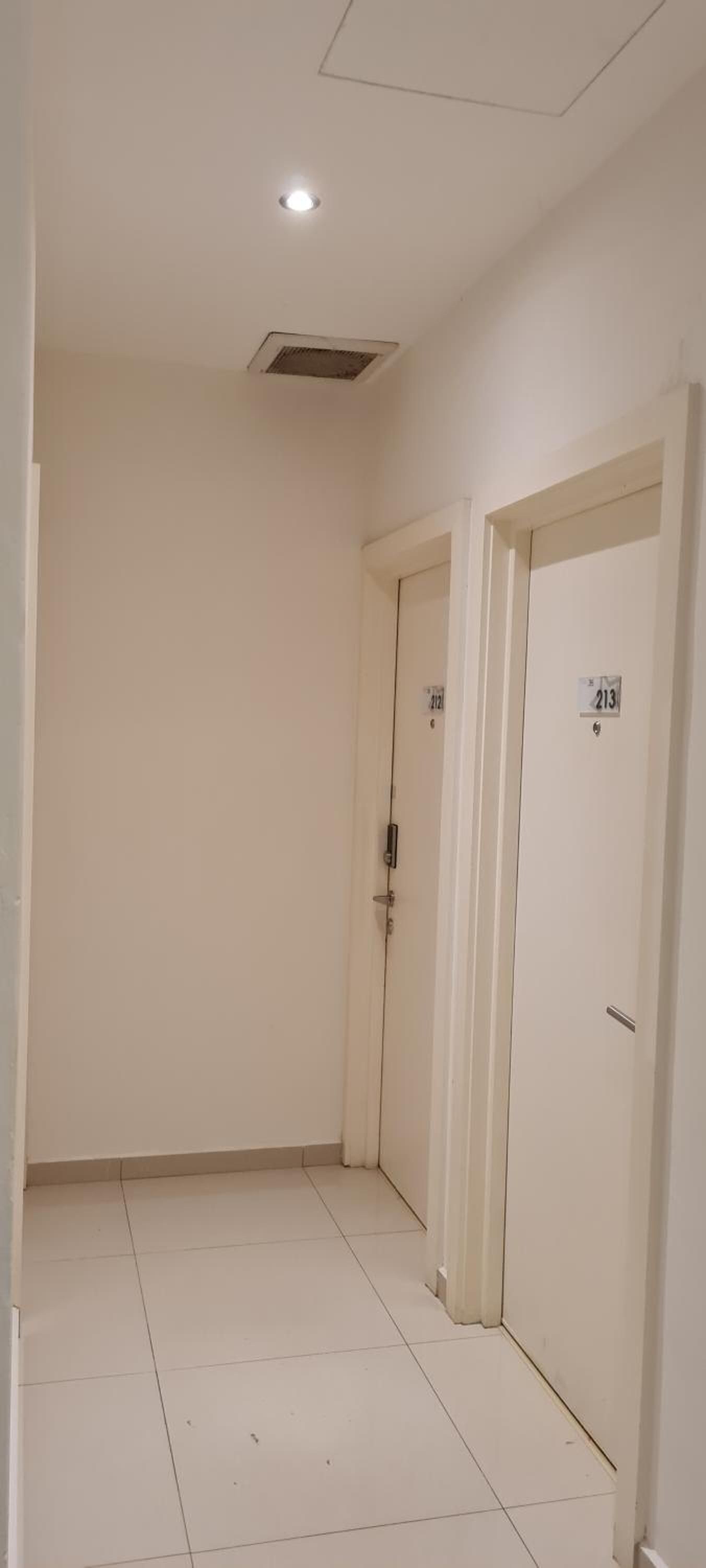 A hallway with two doors, each marked with a number.