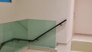 A hotel room with a ceiling fan, a glass staircase, and a bed. - Star Tree Homestay (Kuantan)