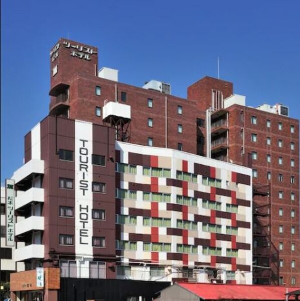A multi-story hotel with a prominent sign reading "TOURIST HOTEL". - Matsumoto Tourist Hotel (Matsumoto)