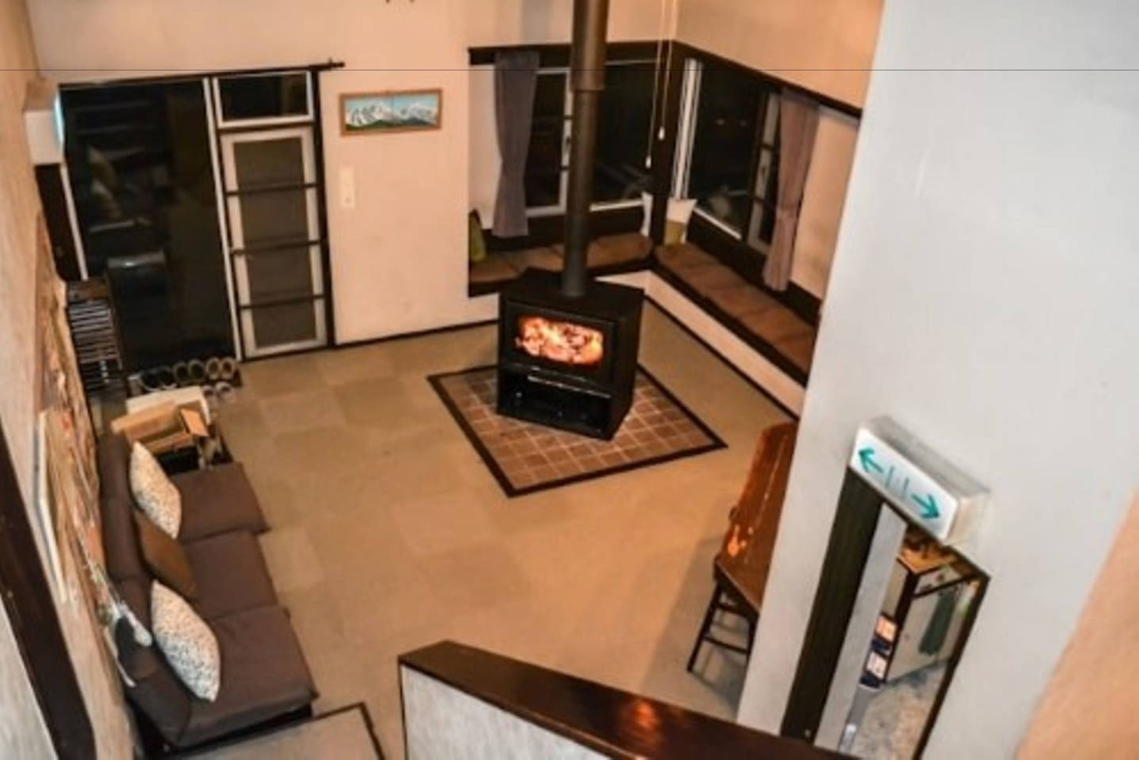 A living room with a fireplace, a sofa, and a TV.
