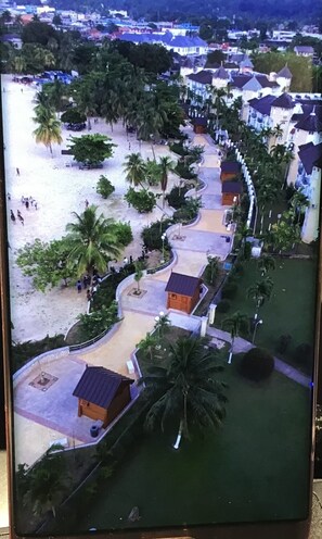 A resort with a beachfront, palm trees, and a curved pathway leading to small cabins. - The McFarlane's Place is right in the heart of Ocho Rios Jamaica. (Ocho Rios)