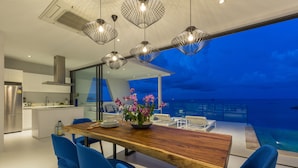 Una cocina moderna con comedor y vistas a una piscina.