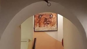 A staircase with a wooden handrail leading up to a landing. - A Luminous and Spacious Medina House with a Rooftop Chillout Terrace  (Asilah)