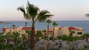 A coastal hotel with multiple buildings, palm trees, and a view of the sea. - New Owner Special! - 2br/2ba - Oceanview/private Beach (Cabo San Lucas)
