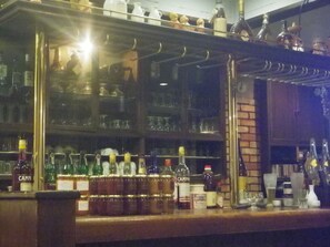 A bar area with shelves stocked with various bottles and glasses. - Resort Inn Murata (Iiyama)