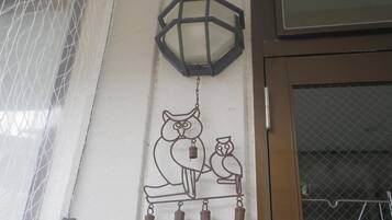 A wall-mounted decorative piece with an owl and a lantern.