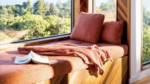 A room with a large window offering a view of a lake and hills. - A Sanctuary to Relax and Refresh all your Senses (Inverness)