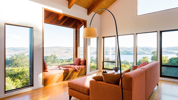 A spacious room with large windows offering a view of the countryside. - A Sanctuary to Relax and Refresh all your Senses (Inverness)