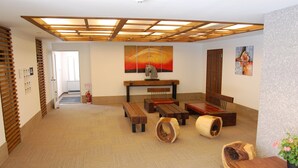 Una habitación amplia con techo de madera, un cuadro grande y un banco.