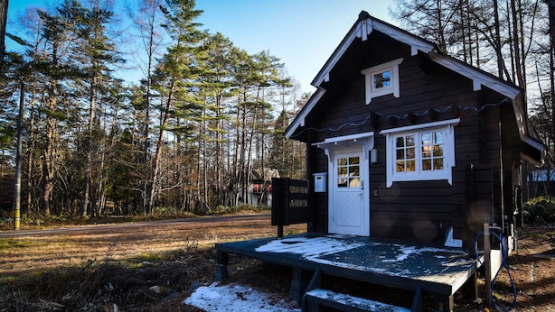 A small cabin with a wooden exterior, a front door, and a bench in front. - Beaver Lodge Hakuba (Hakuba)