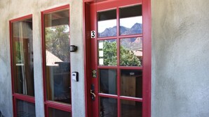 A building with two red-framed windows and a door marked with the number 3. - Walk a Block to Uptown to the main shops, tours, restaurants. (Sedona)