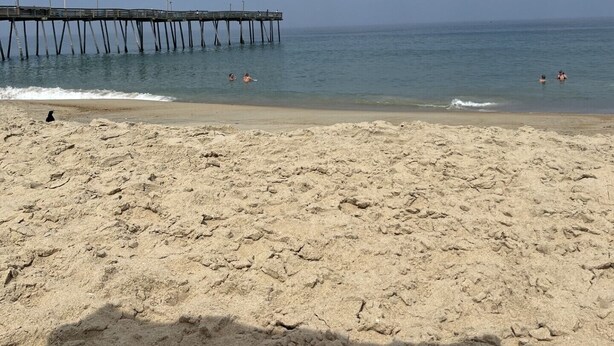 A beach with a pier extending into the water, sandy beach, and clear sky. - Don't Miss Out on the 'Sunshine'; Unwind, Relax, Put Your Feet Up and enjoy! (Kill Devil Hills)