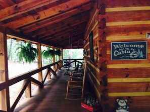 A wooden cabin with a porch, a welcome sign, and a Coca-Cola crate. - Perfect Getaway Lots 2 Do! Upscale Real-Log Cabin & Great Rate! Families/Couples (Blue Ridge)