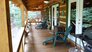 A covered porch with wooden flooring, green chairs, a grill, and a ceiling fan. - Perfect Getaway Lots 2 Do! Upscale Real-Log Cabin & Great Rate! Families/Couples (Blue Ridge)
