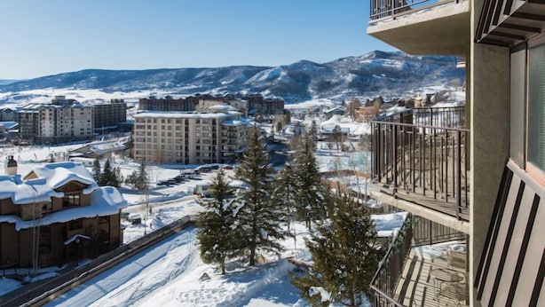 A high-rise building with balconies overlooking a snowy landscape and mountains. - Ski-in, Walk-out, Views of Ski Slopes, Indoor Pool, Discount Lift Tix (Steamboat Springs)