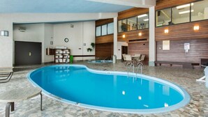 An indoor swimming pool with a tiled floor, wooden panel walls, and a ceiling with recessed lighting. - Ski-in, Walk-out, Views of Ski Slopes, Indoor Pool, Discount Lift Tix (Steamboat Springs)