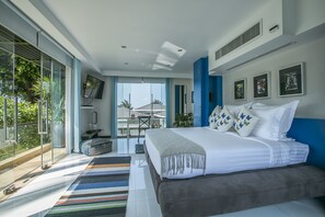 A modern bedroom with a large bed, a glass door leading to a balcony, and a flat-screen TV on the wall.
