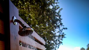 A wooden deck with a showerhead. - Perfect Location, Walk to Beach, Infinity Pool, Luxury Decor, Fast Free Wifi! (Dominical)