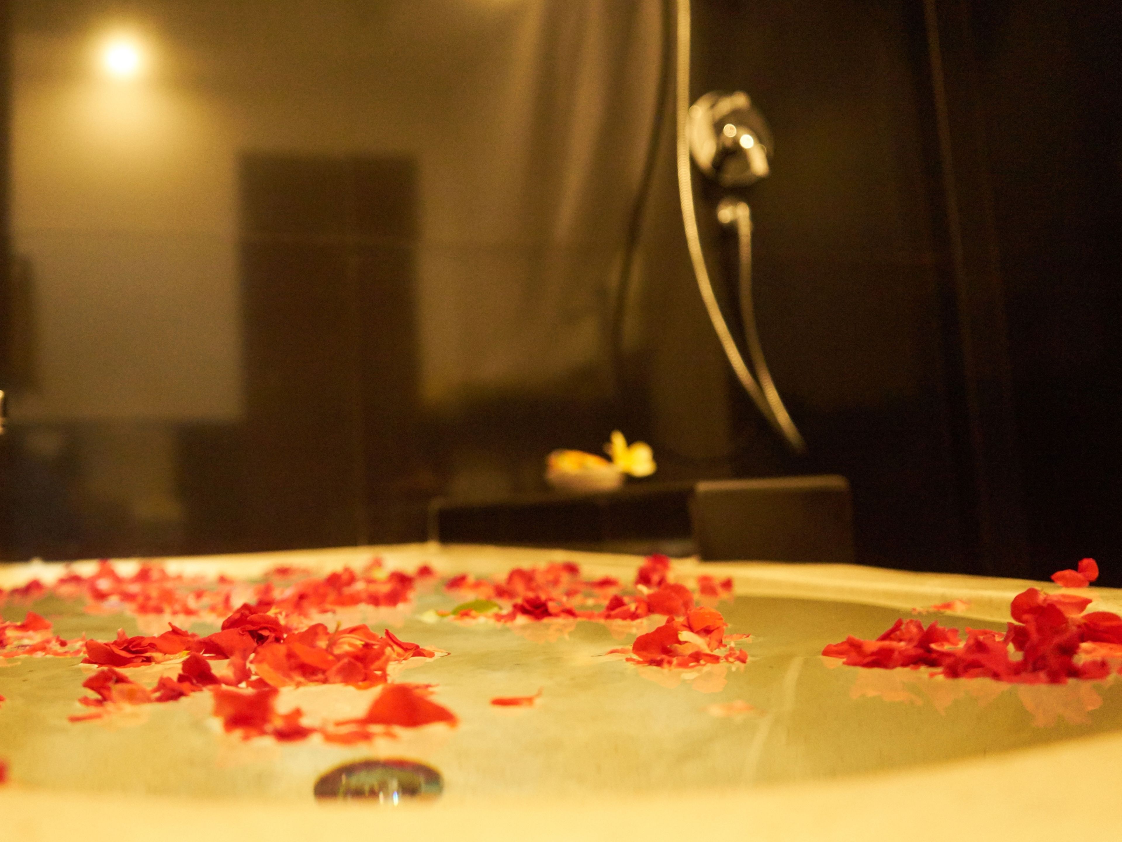 A bathtub filled with rose petals.