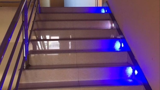 A staircase with blue lighting and a door marked 4018. - Victory hotel (Guangzhou)