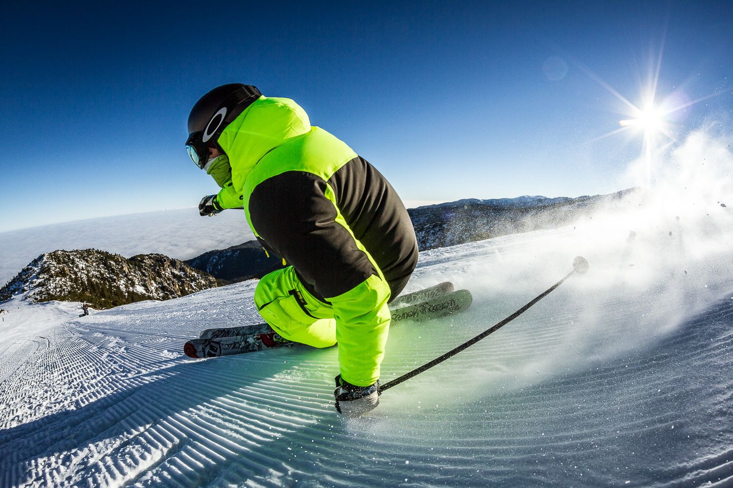 A person skiing on a snowy slope with a clear sky.