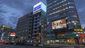 A modern hotel with multiple floors, a prominent sign for 'TSUTAYA' on the facade, and a visible storefront for 'Tully's Coffee' at street level. - Sanco Inn Nagoyashinkansenguchi Annex (Nagoya)