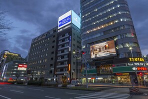 A modern hotel with multiple floors, a prominent sign for 'TSUTAYA' on the facade, and a visible storefront for 'Tully's Coffee' at street level. - Sanco Inn Nagoyashinkansenguchi Annex (Nagoya)