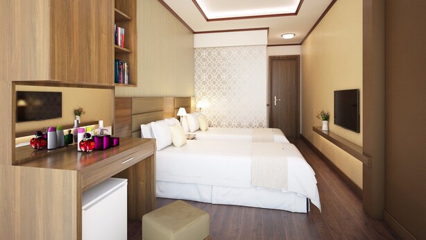 A modern hotel room with a large bed, a desk with a computer, a TV, and a bookshelf. - Hotel Bel Ami Hanoi (Hanoi)