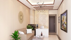 A modern living room with a sofa, coffee table, and a potted plant. - Hotel Bel Ami Hanoi (Hanoi)