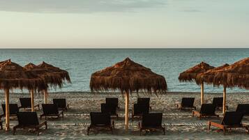 On the beach, sun loungers, beach umbrellas