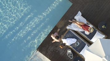 Outdoor pool, open 10:00 AM to 6:30 PM, pool umbrellas, pool loungers