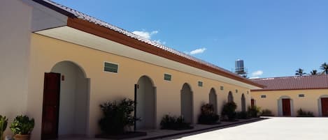 A building with multiple arched doorways and a flat roof.