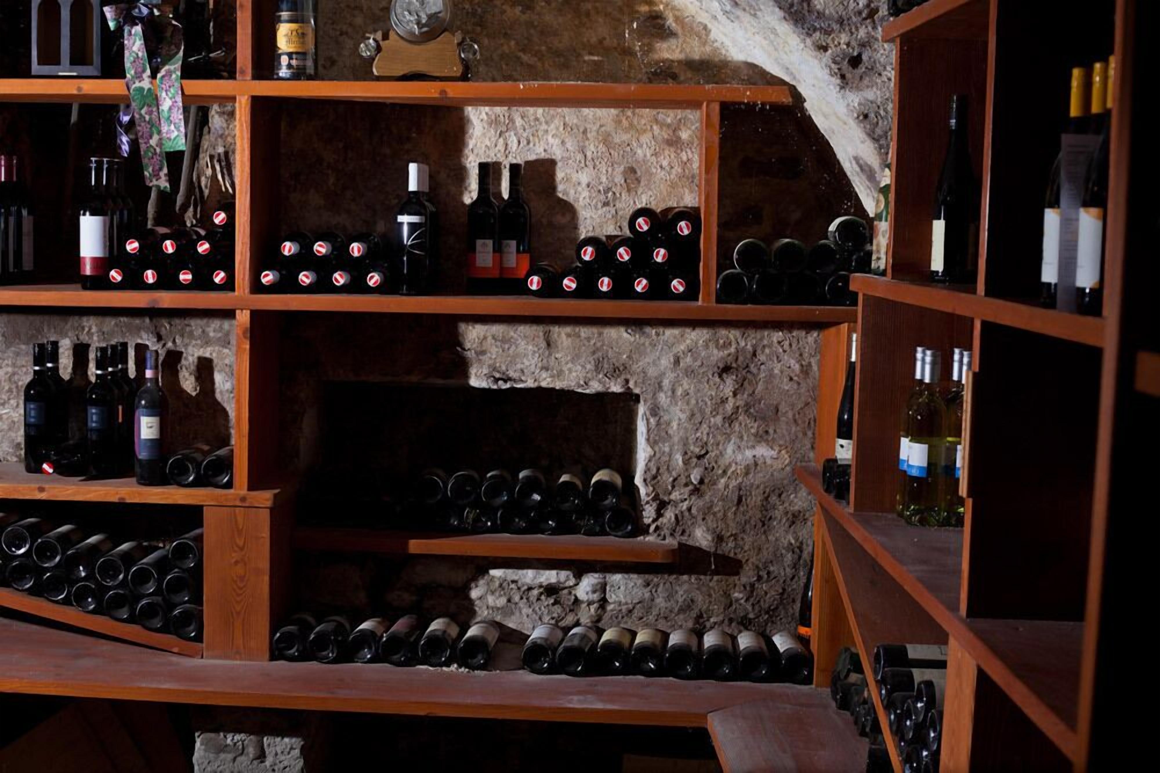 A wine cellar with wooden shelves and wine racks.