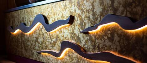 A reception desk with a textured marble surface and wave-shaped cutouts.